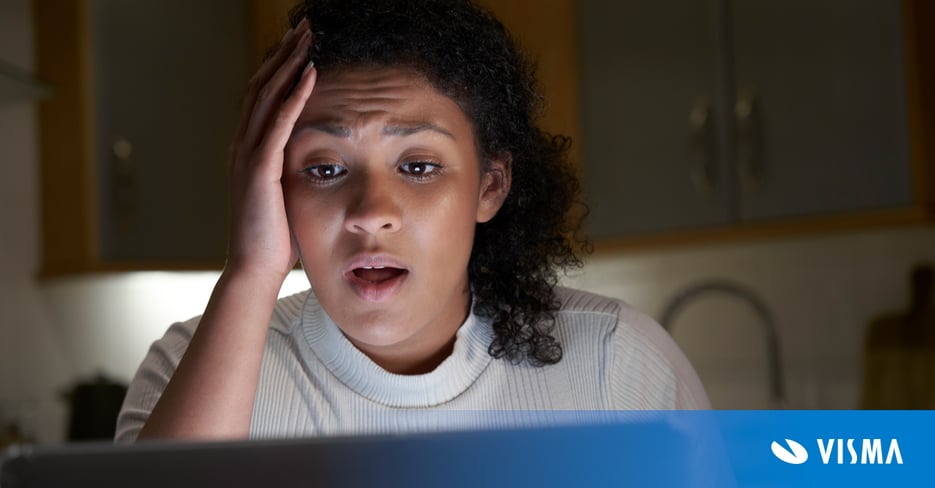 Unhappy woman working from home office with computer being victim of cyber crime